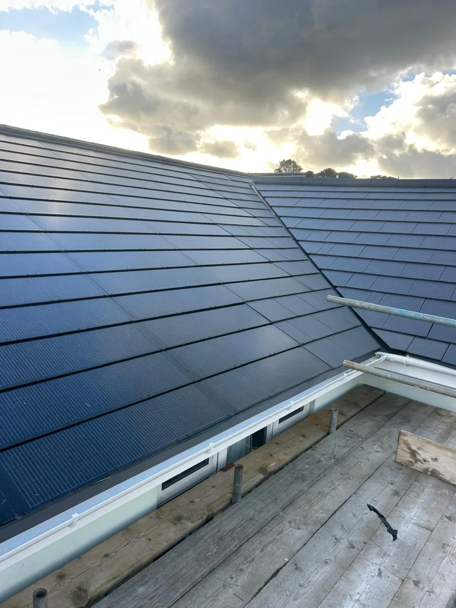 Integrated solar tiles during a SolarCover UK installation in Guernsey